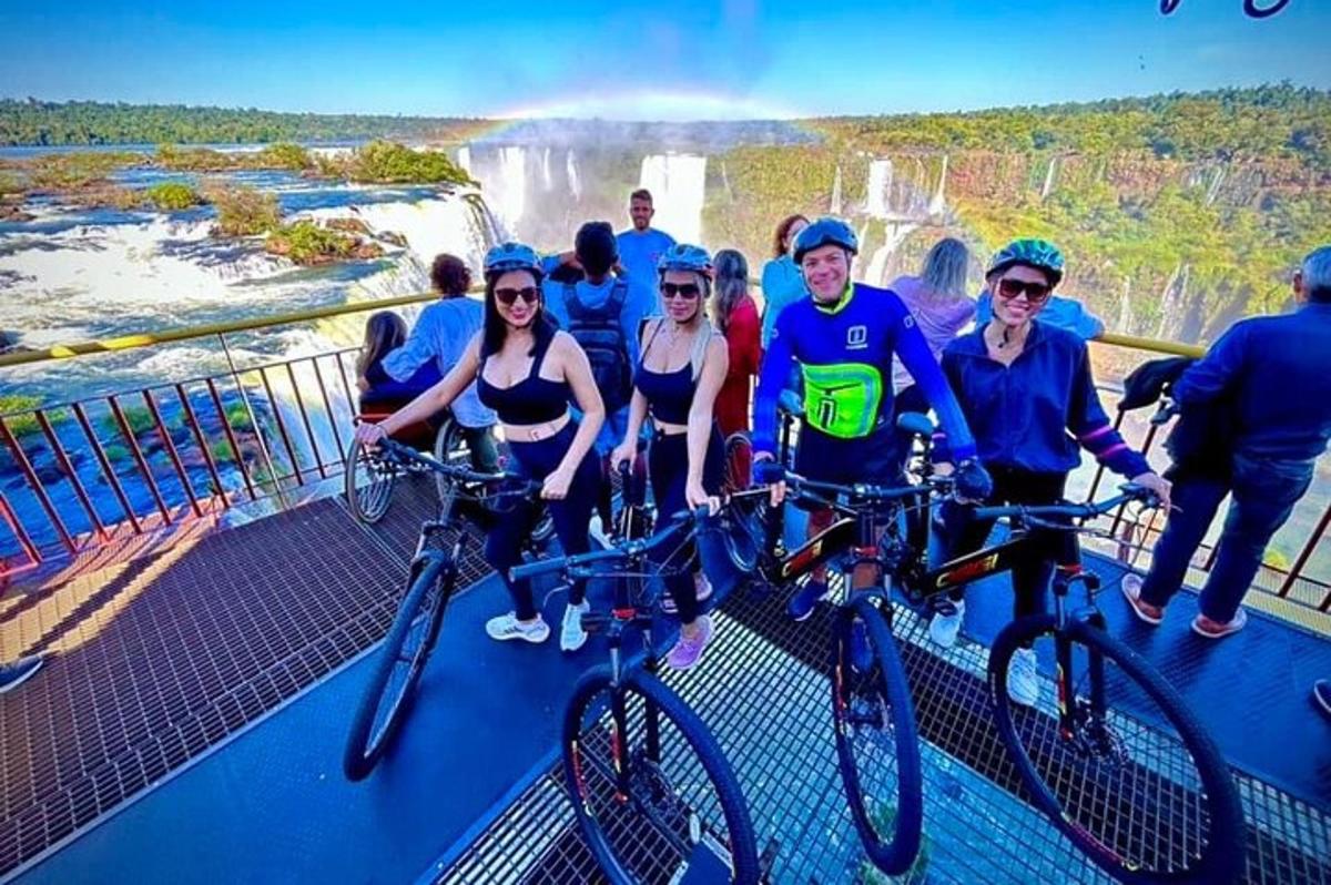 a group of people on their bikes at the waterfall