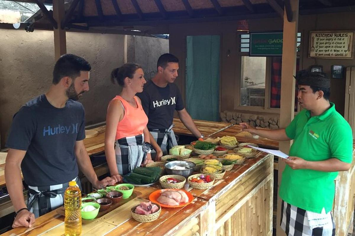 a group of people standing around a table with food