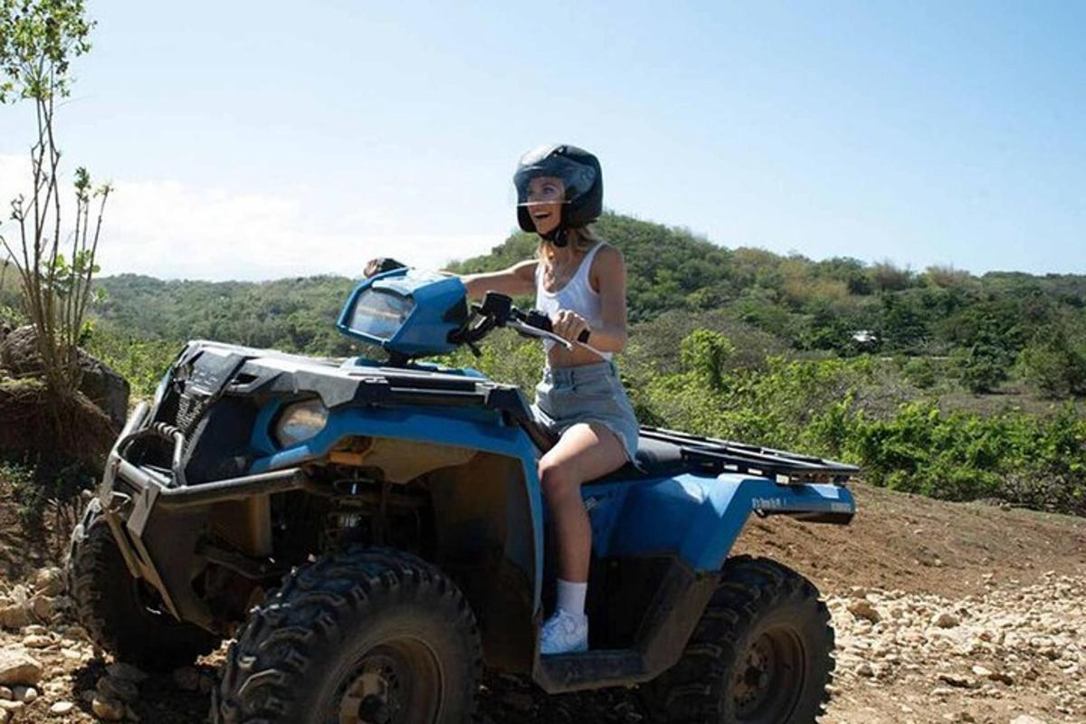 a woman sitting on the back of a atv