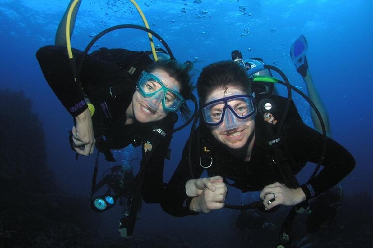 two people posing for a picture while scuba diving