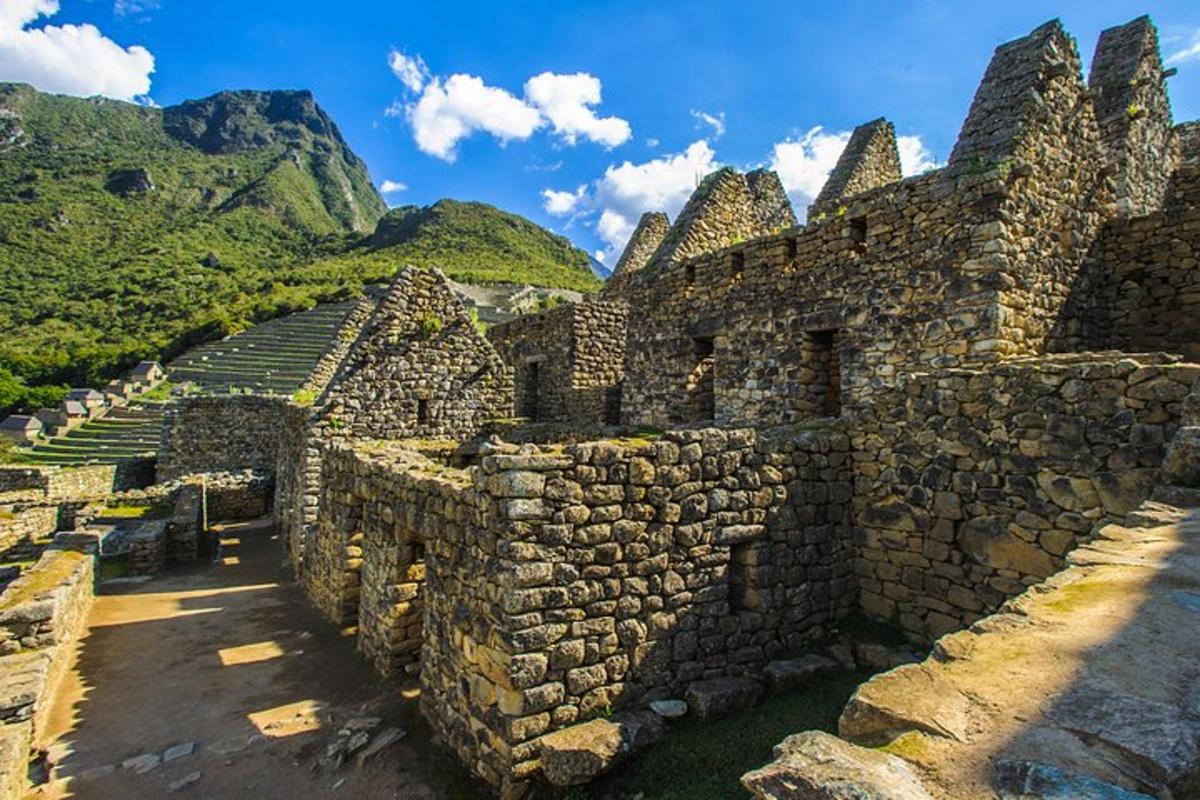 an old stone building with a mountain in the background
