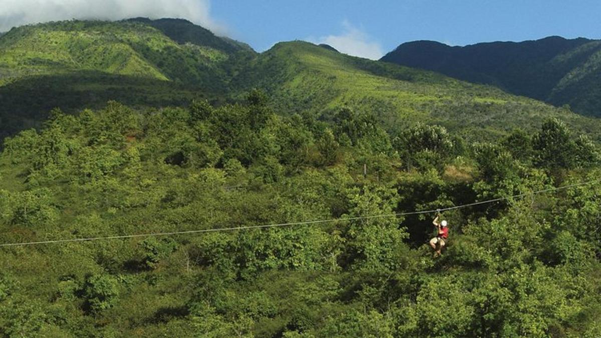 osoba kráčajúca po zipline v horách