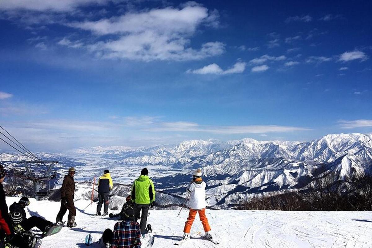 a group of people standing on top of a snow covered mountain