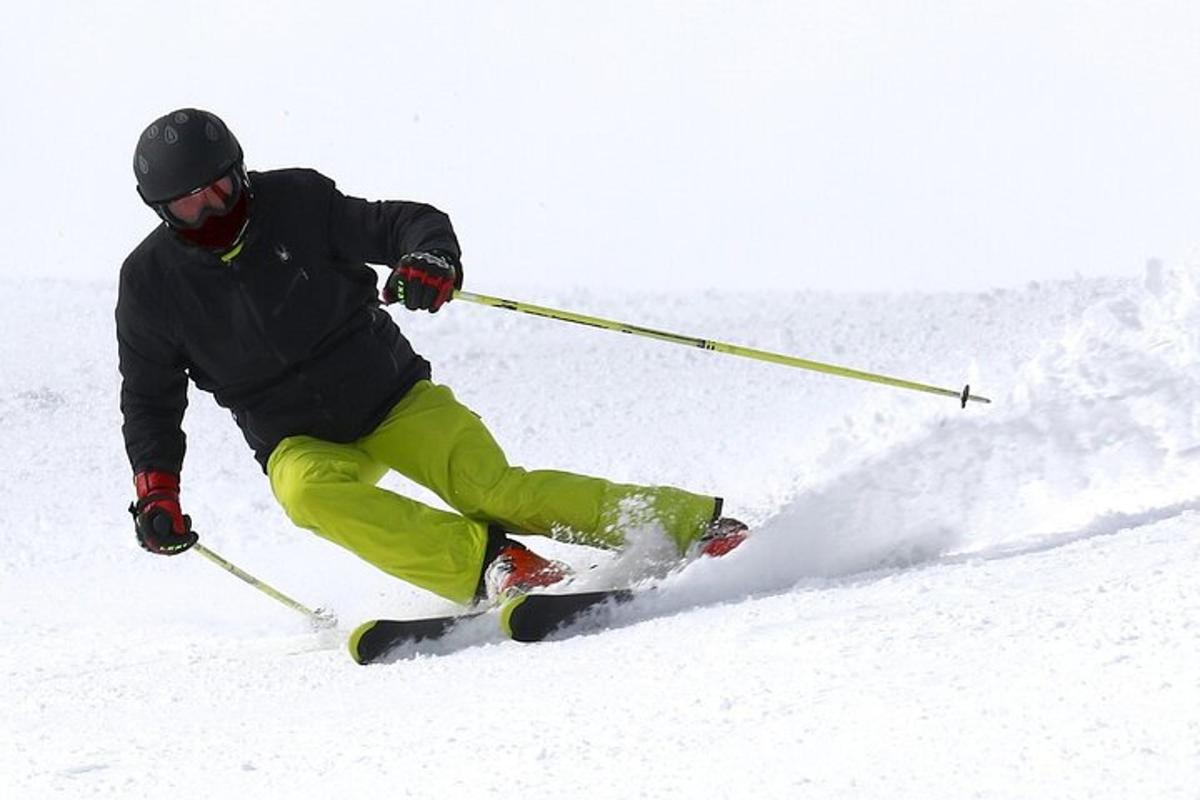 a man is skiing down a snow covered slope