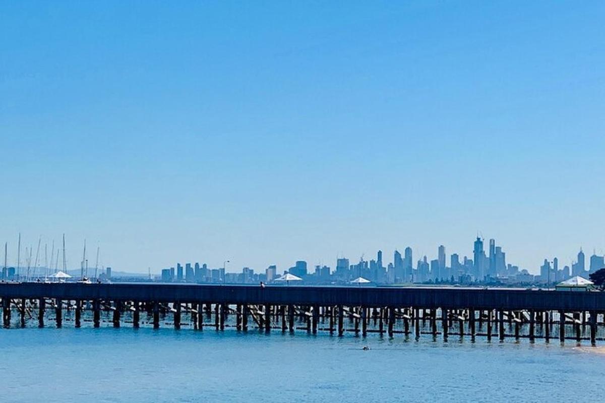 a pier in the water with a city in the background
