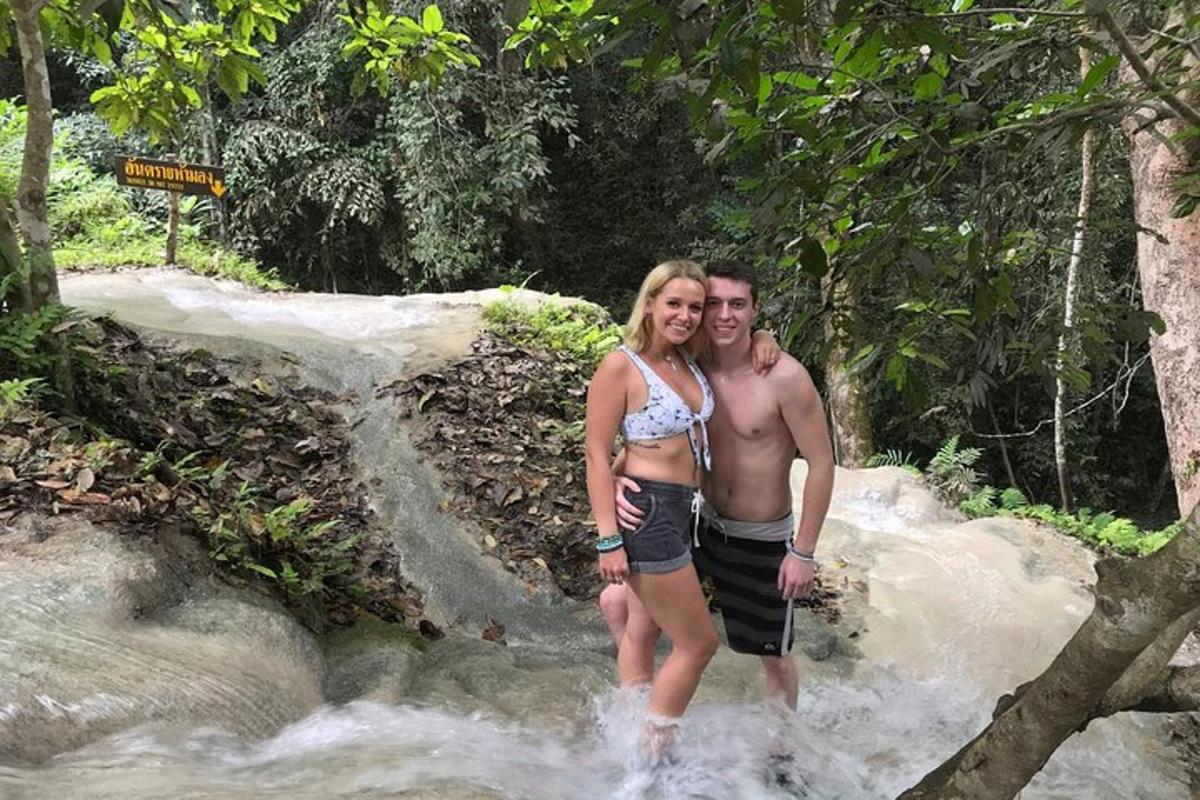 a man and a woman standing in a river