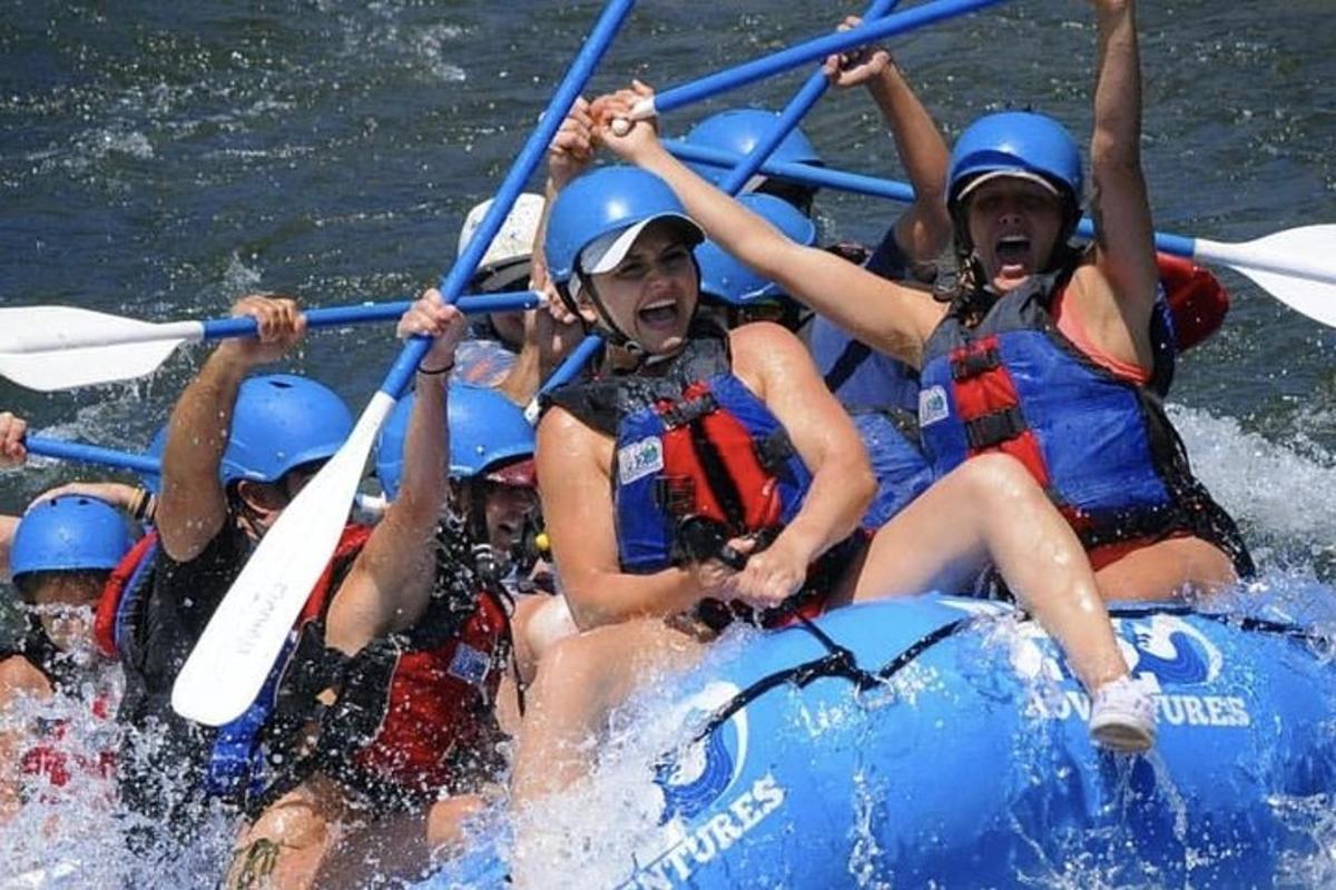 a group of people in a raft in the water