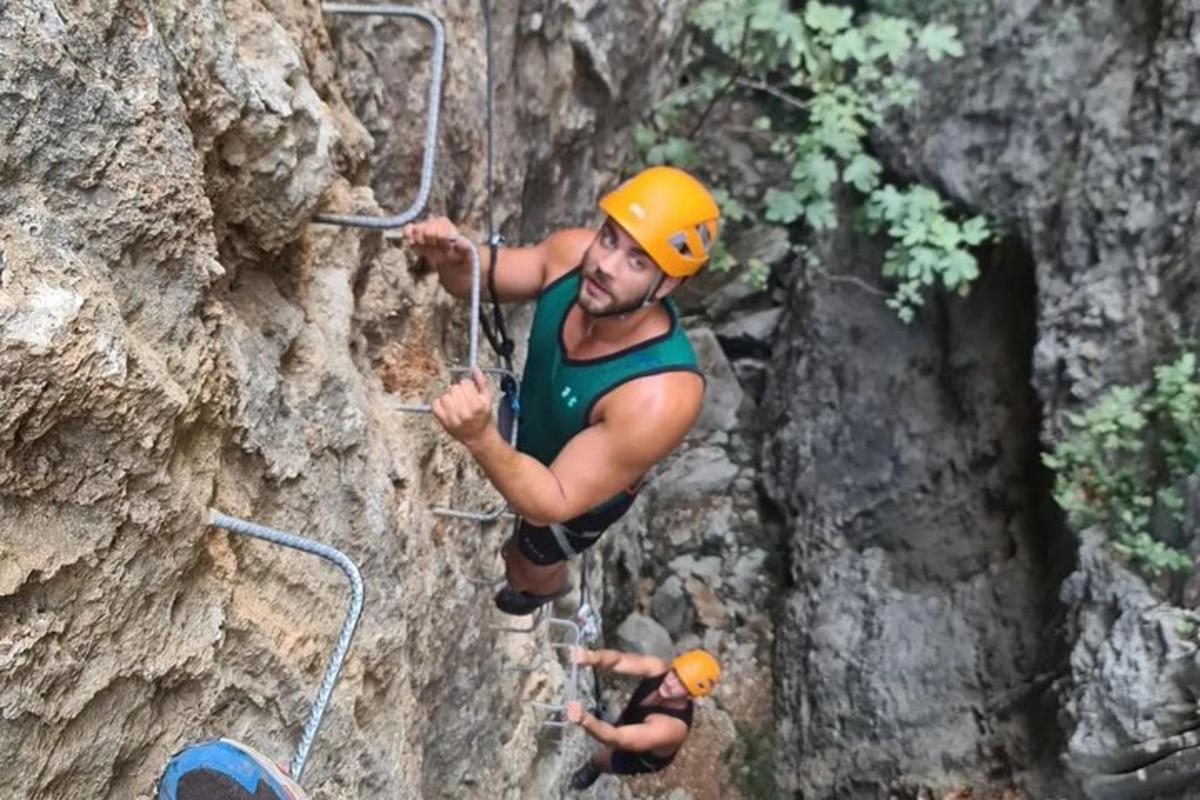 due uomini stanno scalando una parete rocciosa