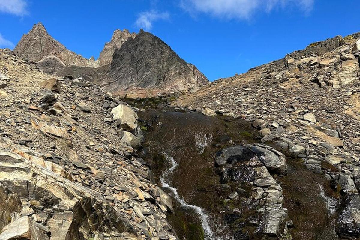 a mountain with a stream of water on a rocky slope