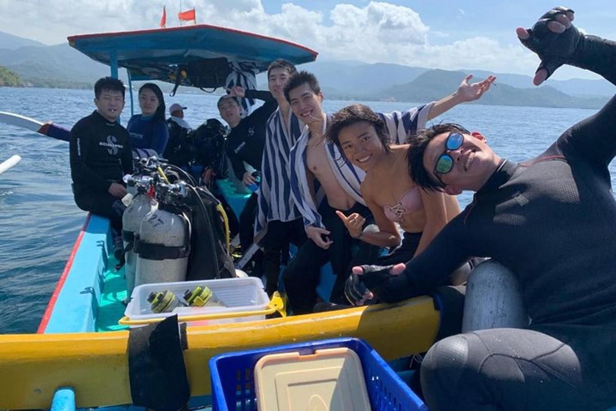 a group of people on a boat in the water