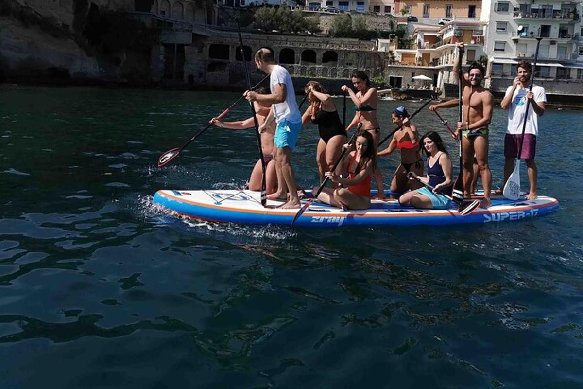 a group of people on a paddle board in the water