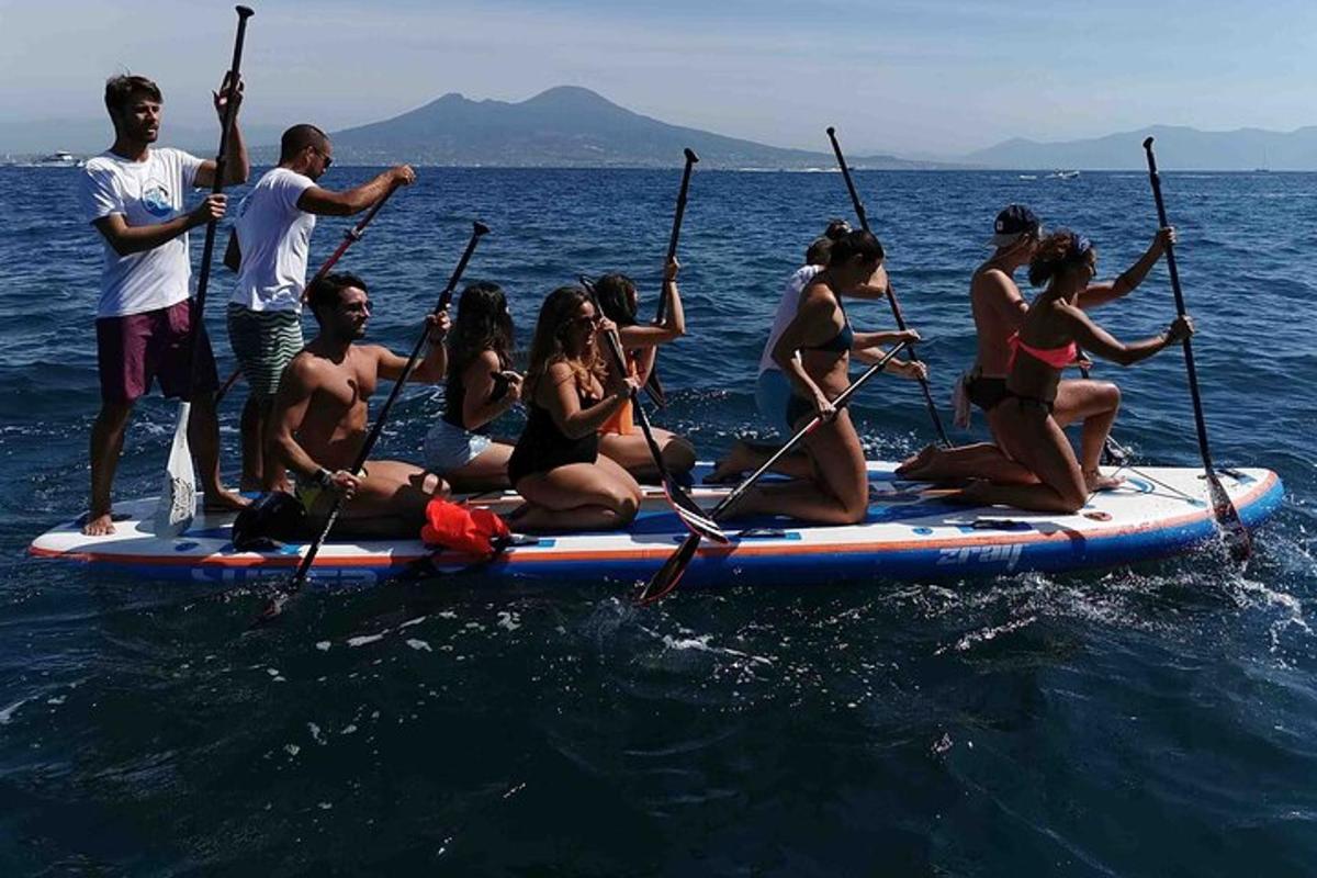 a group of people on a paddle board in the water