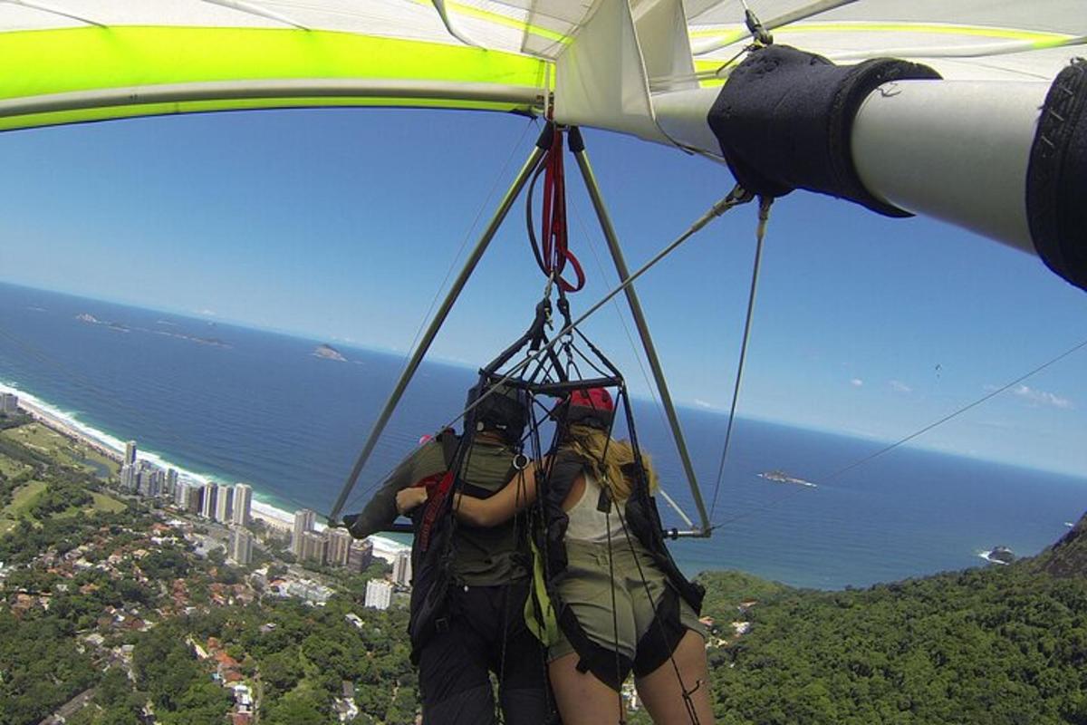 two people hanging from the side of a parachute