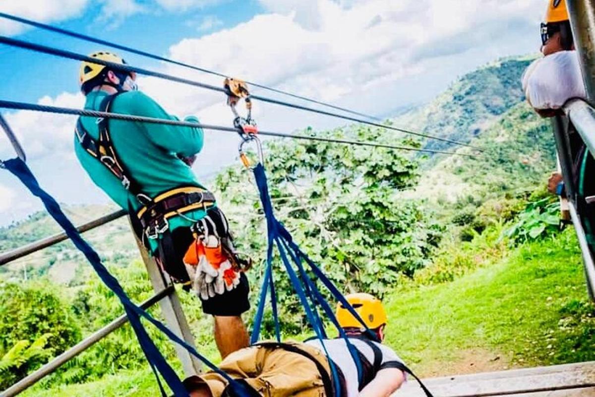 Un grupo de personas en una tirolina en las montañas.