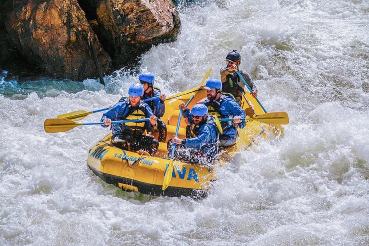a group of people in a raft in a river