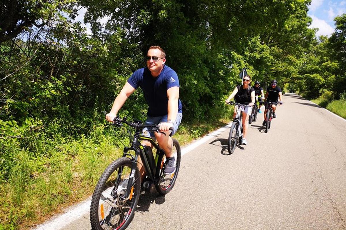 a group of people riding bikes down a road