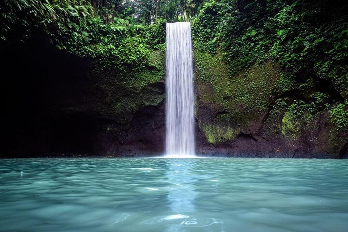 a waterfall in the middle of a pool of water