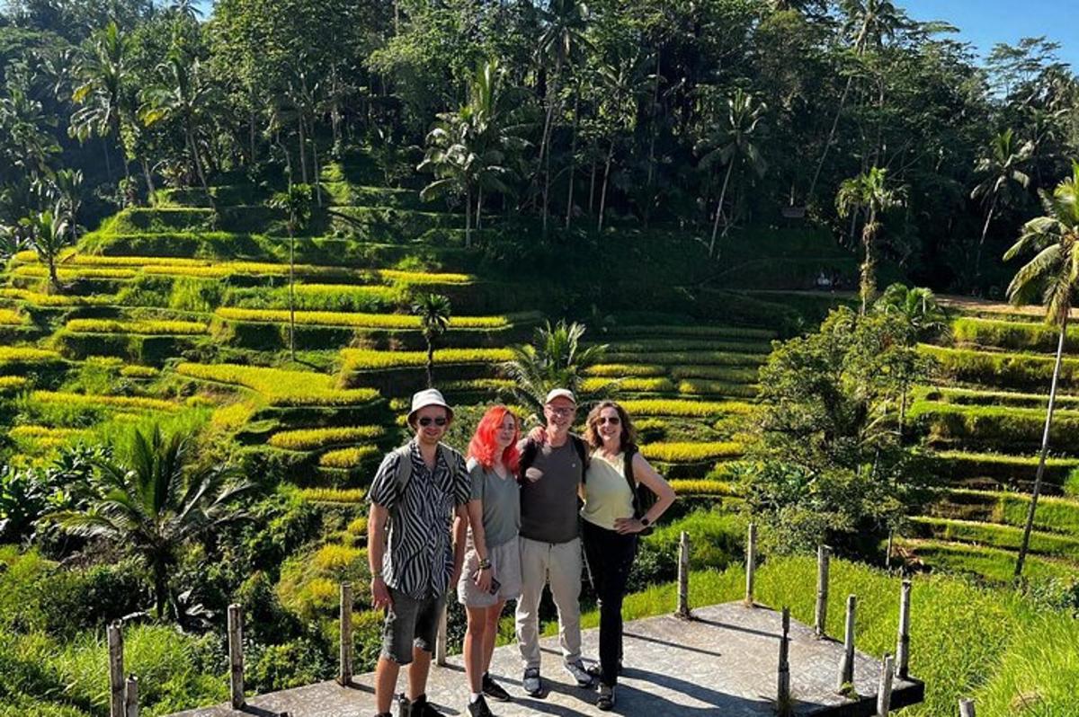a group of people standing in front of a garden