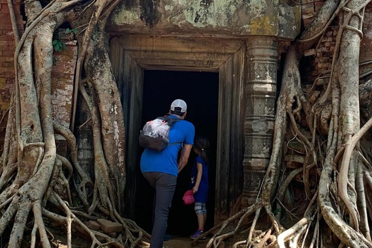 un uomo e un bambino che camminano in un tunnel di alberi