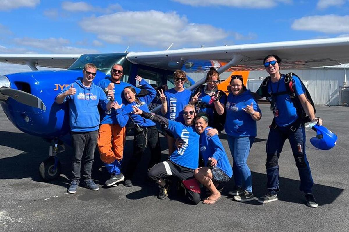 a group of people posing in front of a plane