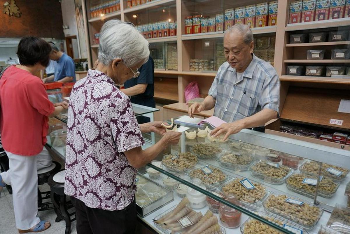 seorang lelaki dan wanita yang lebih tua menyediakan makanan di kedai roti