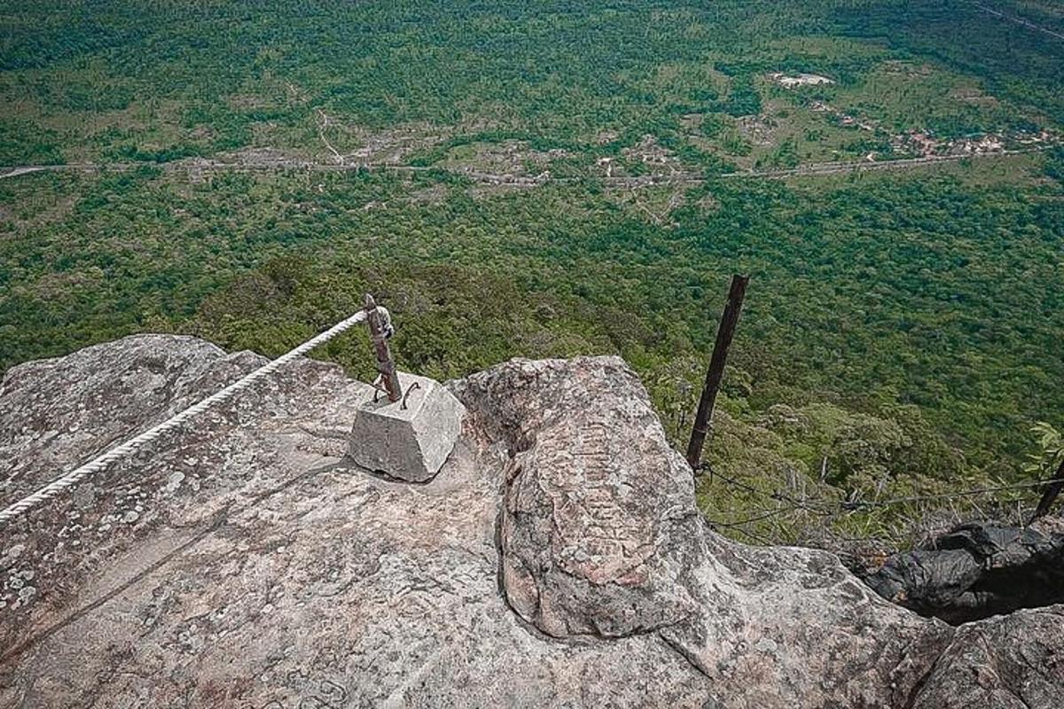 a statue on top of a rock on a mountain