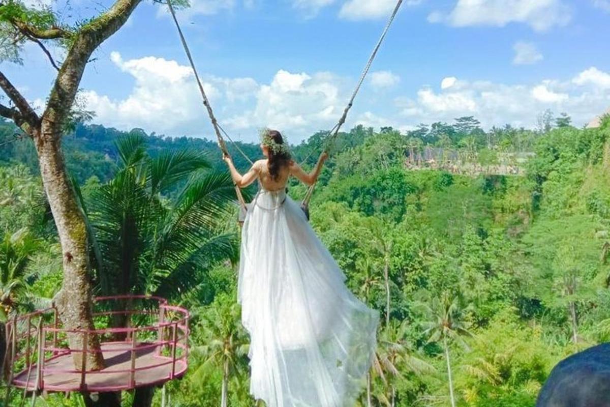 a woman in a wedding dress on a swing