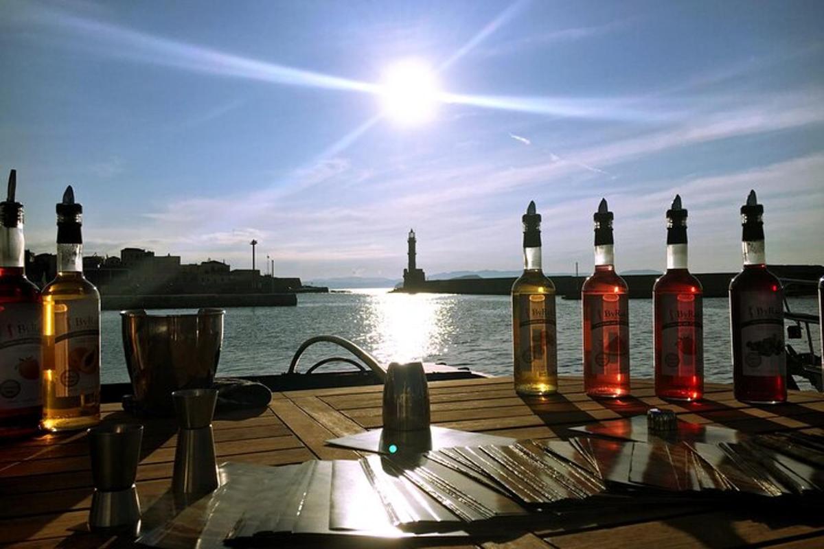 a group of bottles of wine sitting on a table next to the water