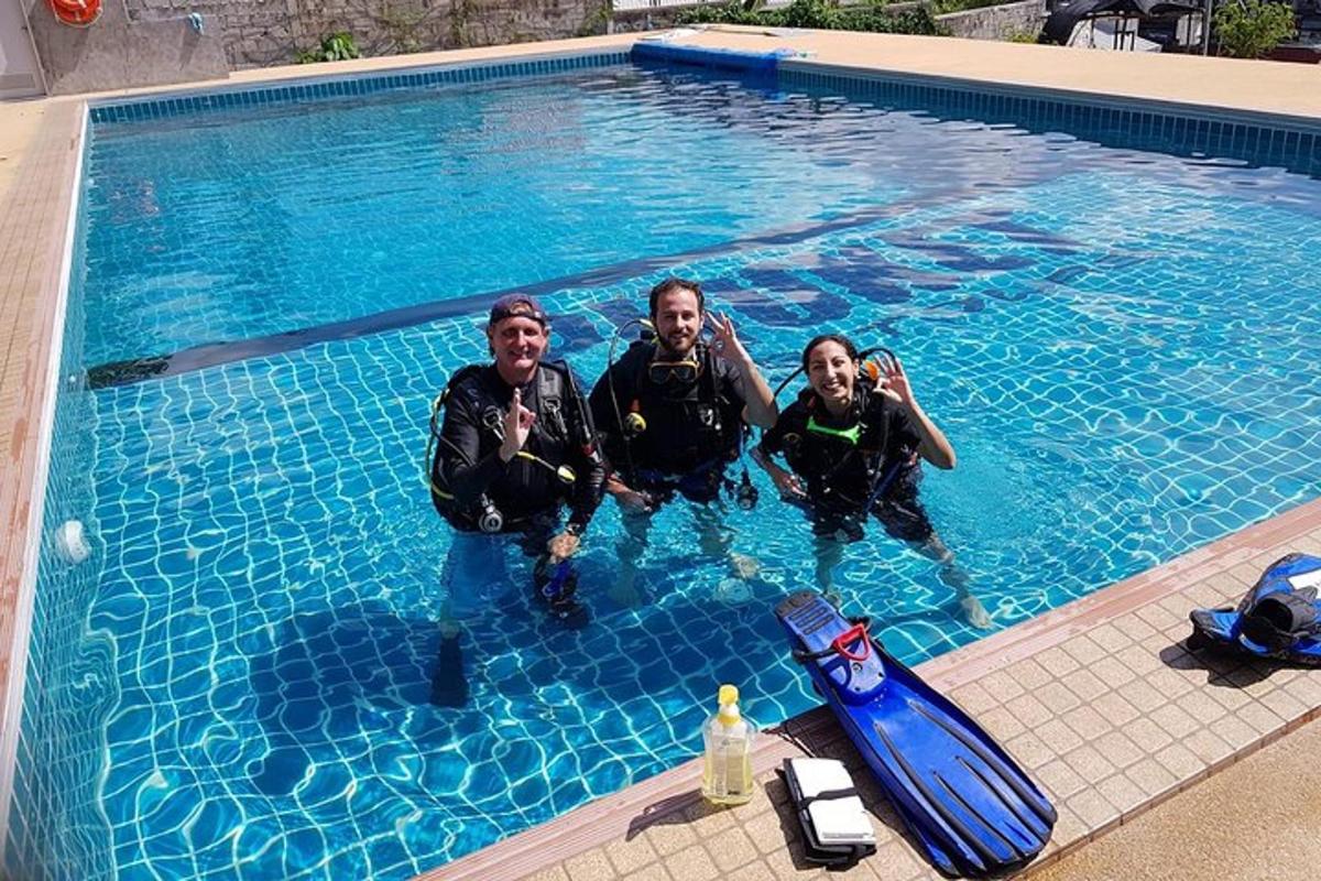 a group of three men in a swimming pool