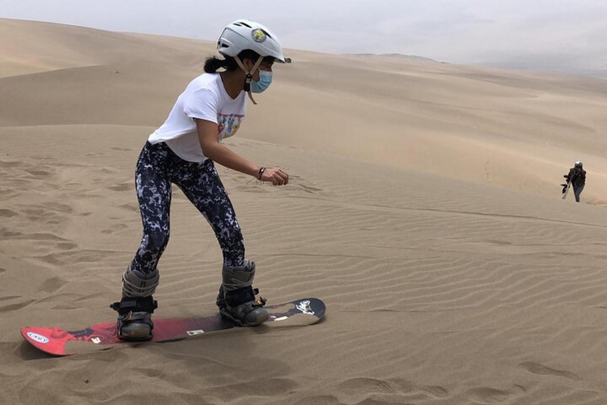a woman standing on a snowboard in the desert