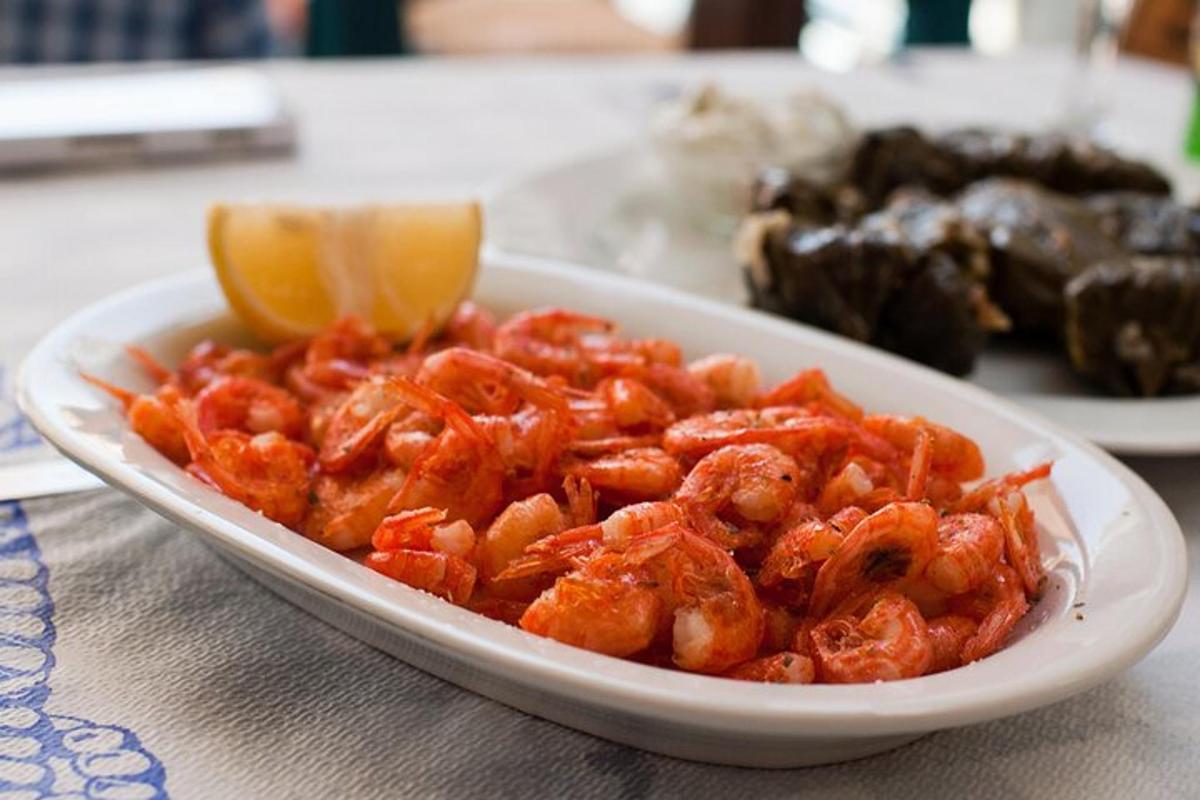 a plate of food with shrimp on a table
