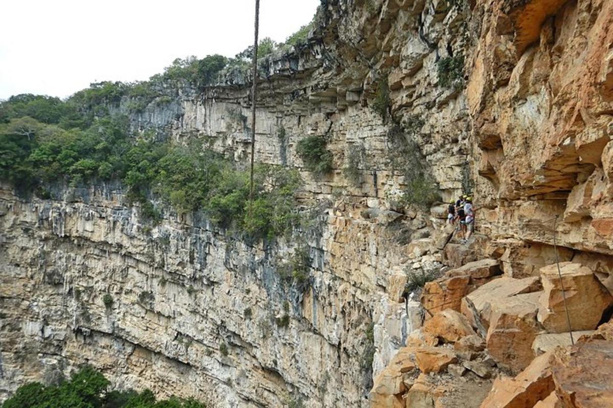 a person rappelling off of a mountain cliff