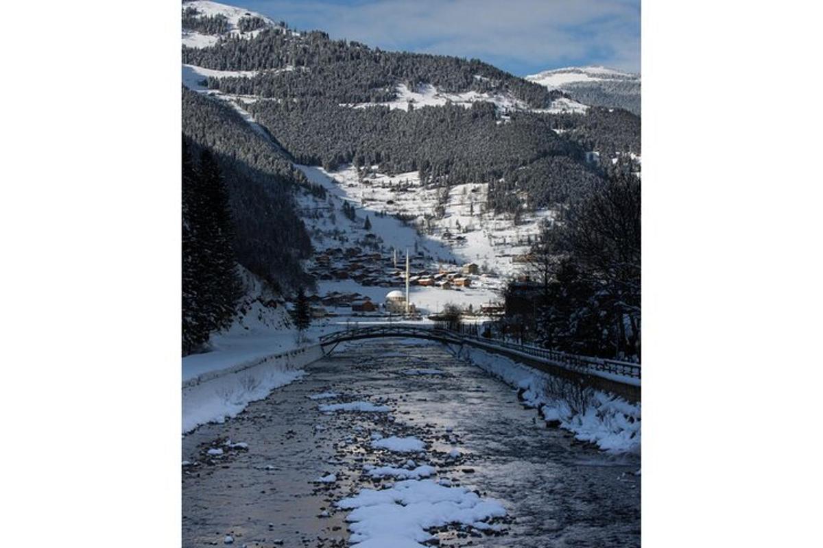 a river in the middle of a snowy mountain