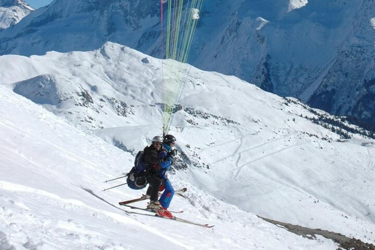 two people are skiing down a snow covered mountain