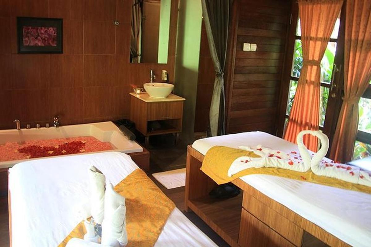 a bathroom with two beds and a tub and a sink