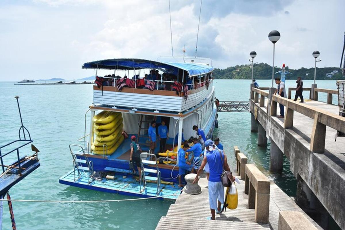 a group of people boarding a boat at a dock