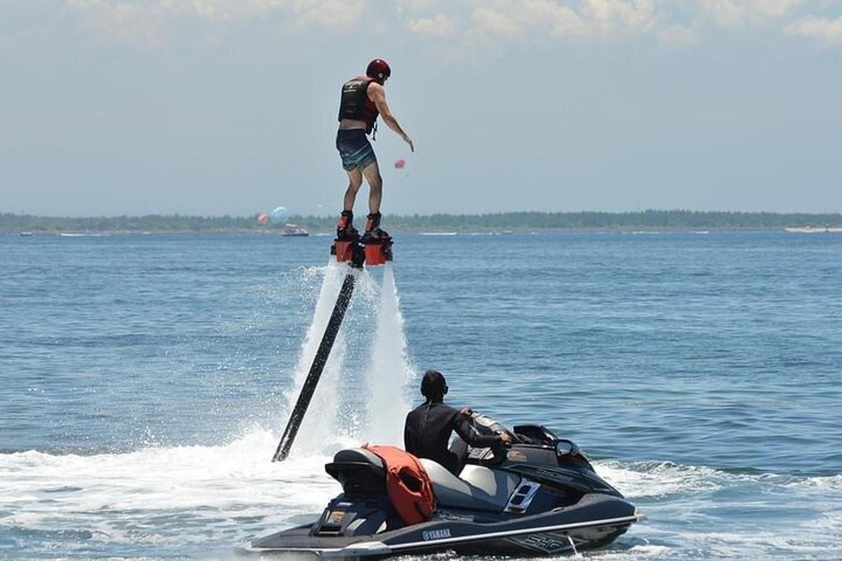 a man standing on top of a jet ski in the water
