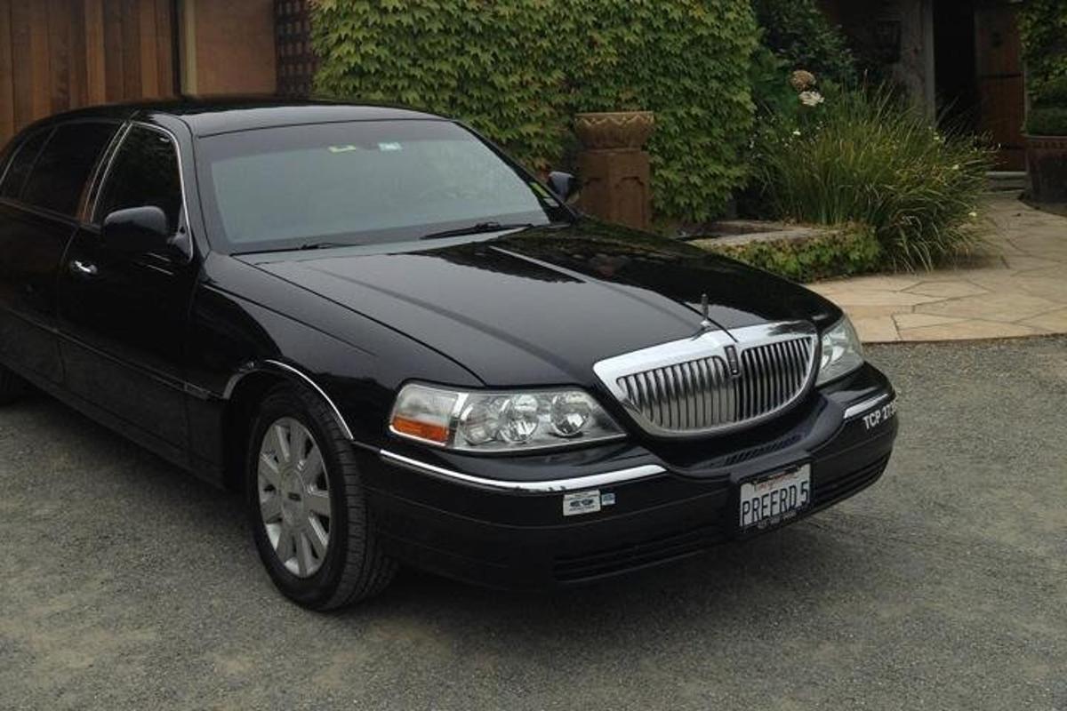 a black car is parked in a driveway
