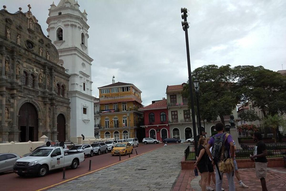 a group of people walking down a street in a city