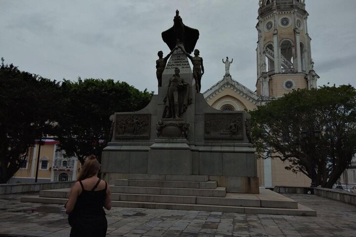 a woman standing in front of a monument in front of a building