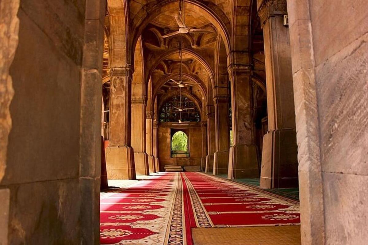 an empty hallway of a building with a red carpet