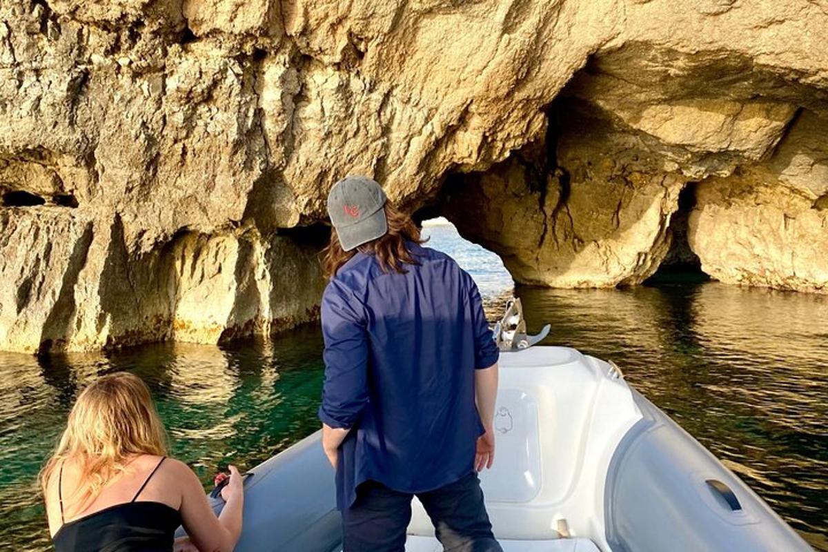a man and woman on a boat in front of a cave