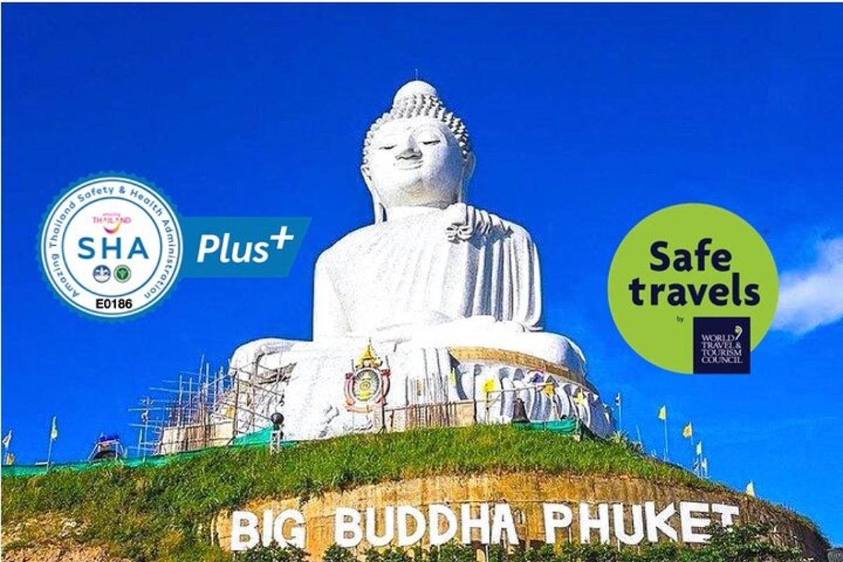 a large white statue sitting on top of a hill