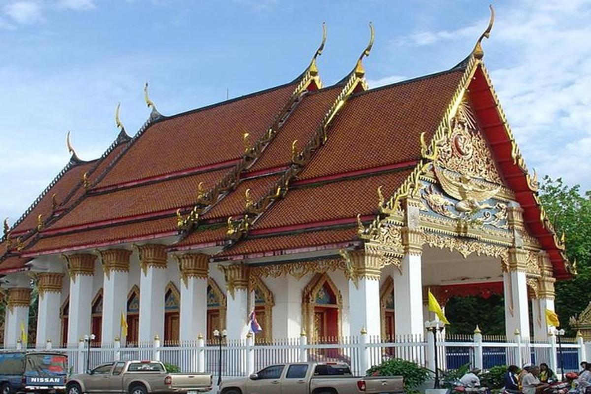 a building with a roof with cars parked in front of it