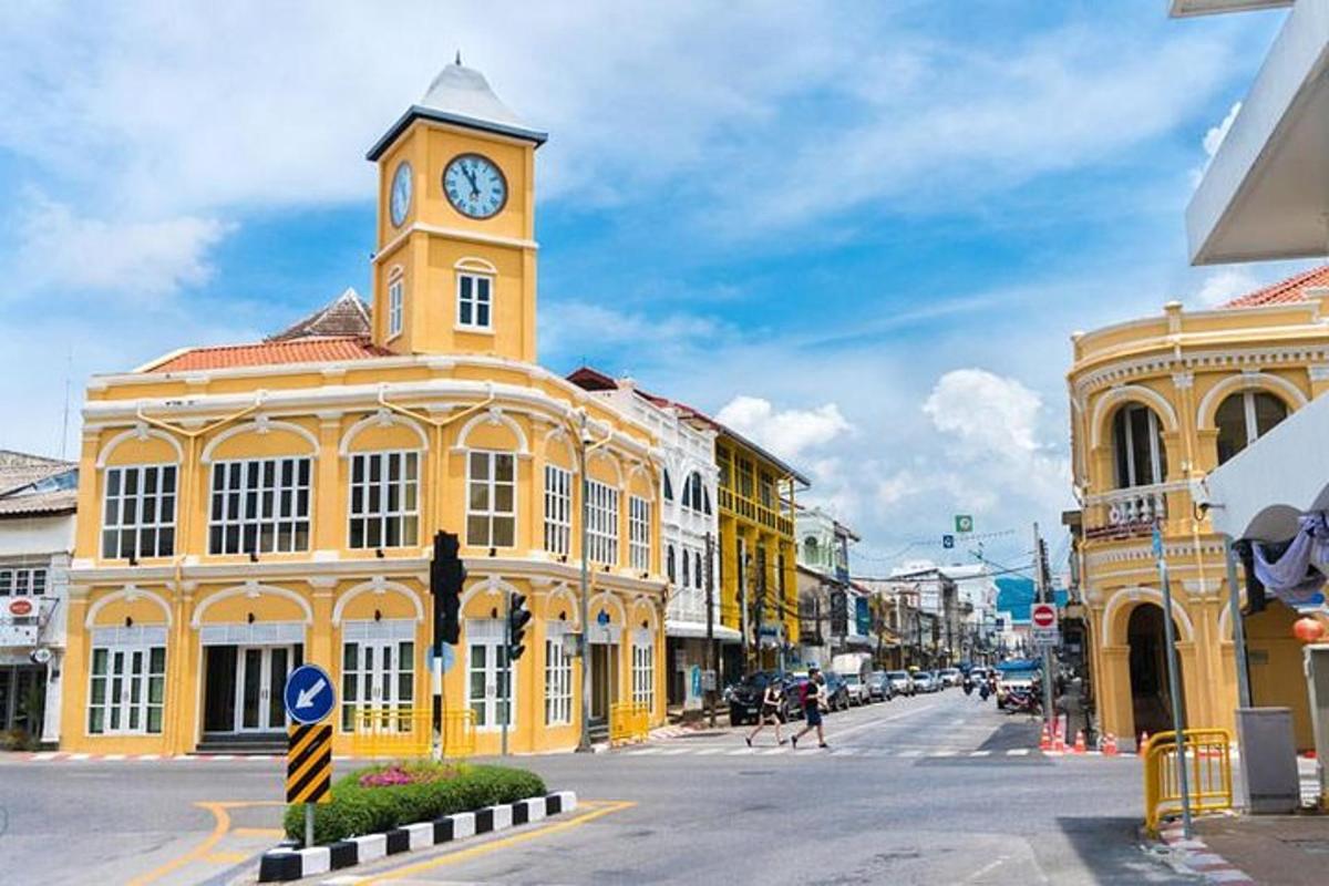 a yellow building with a clock tower on a street