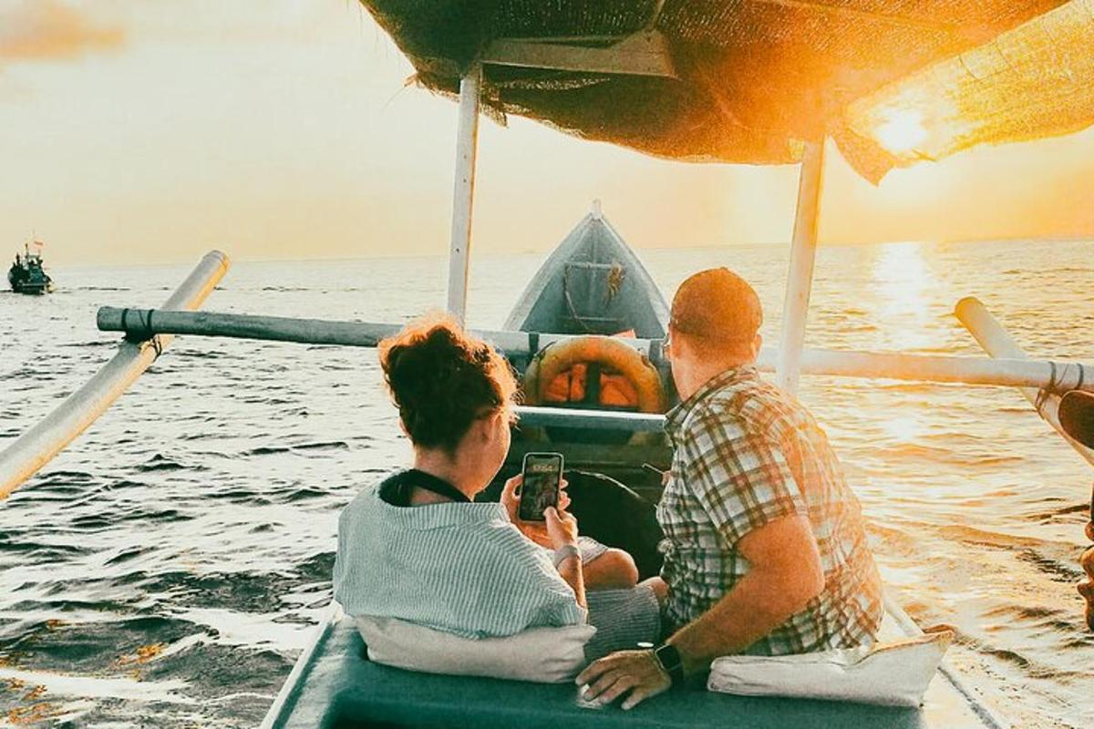 a group of people sitting on a boat in the water