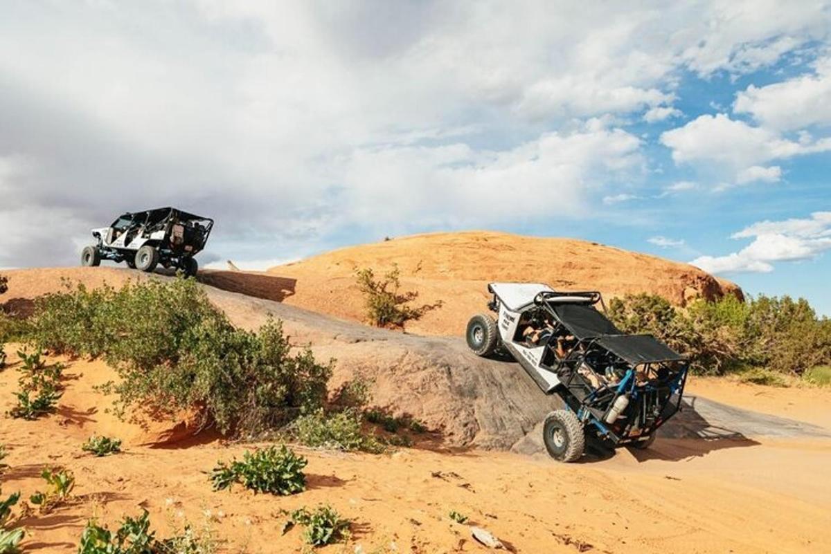 two atvs on top of a hill in the desert