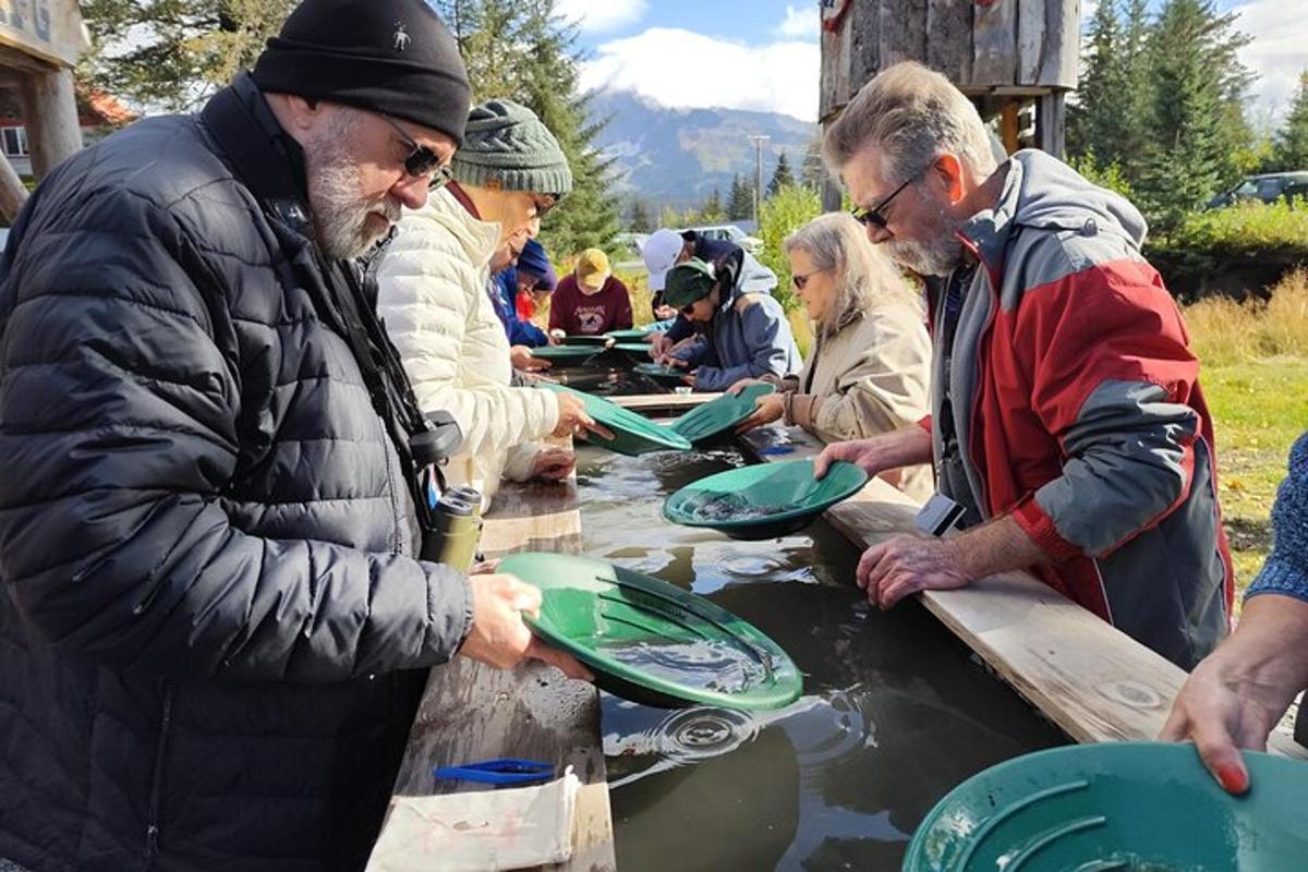 a group of people standing around a table with green plates