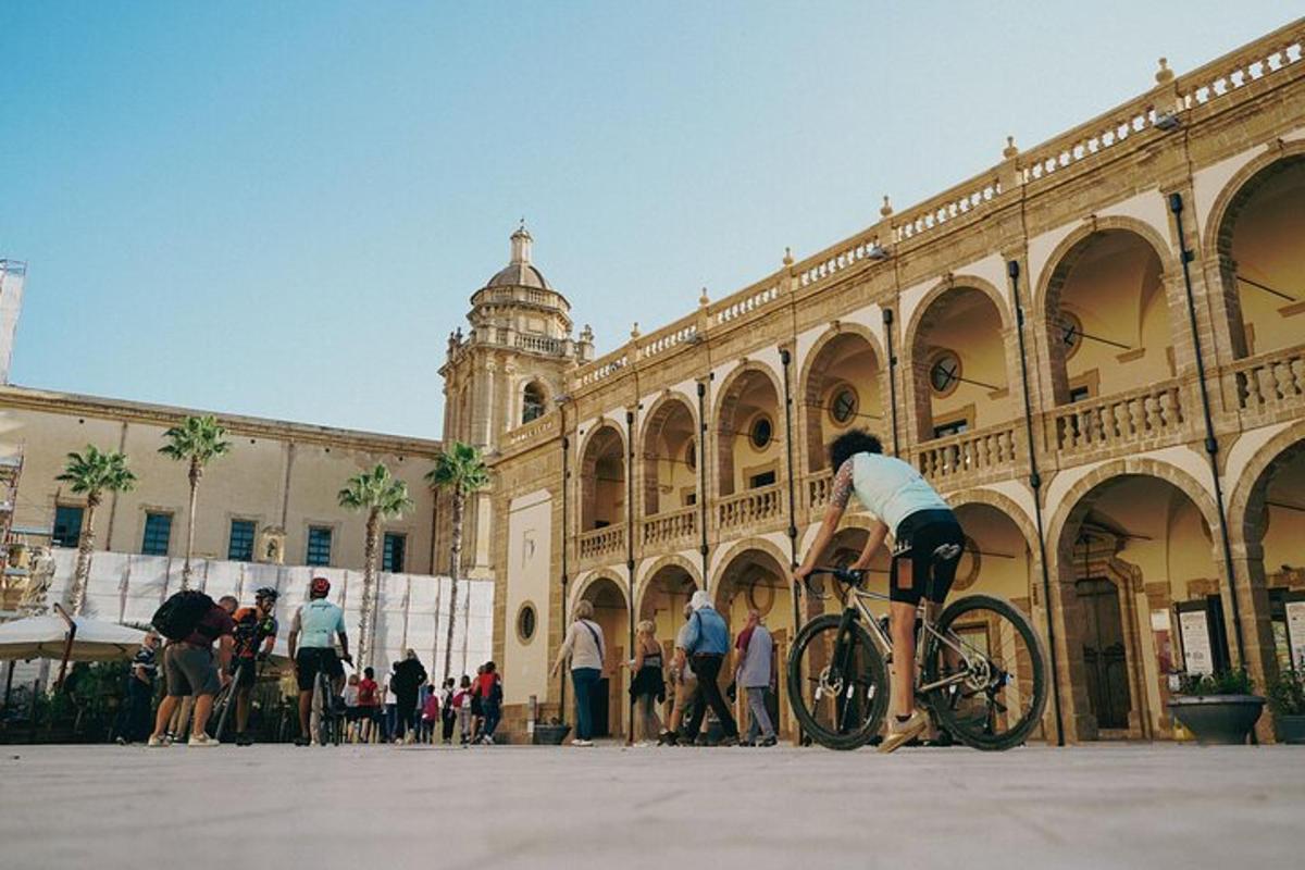 a person riding a bike in front of a building