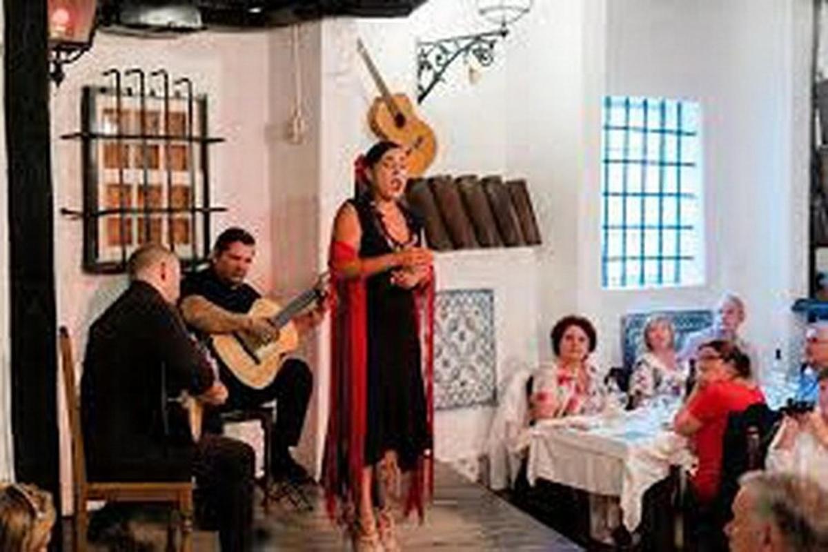 a woman standing in a room with a guitar